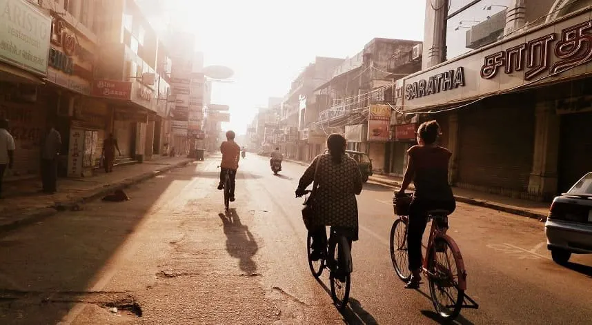 Cyclists riding through the old streets of Pondicherry at sunrise